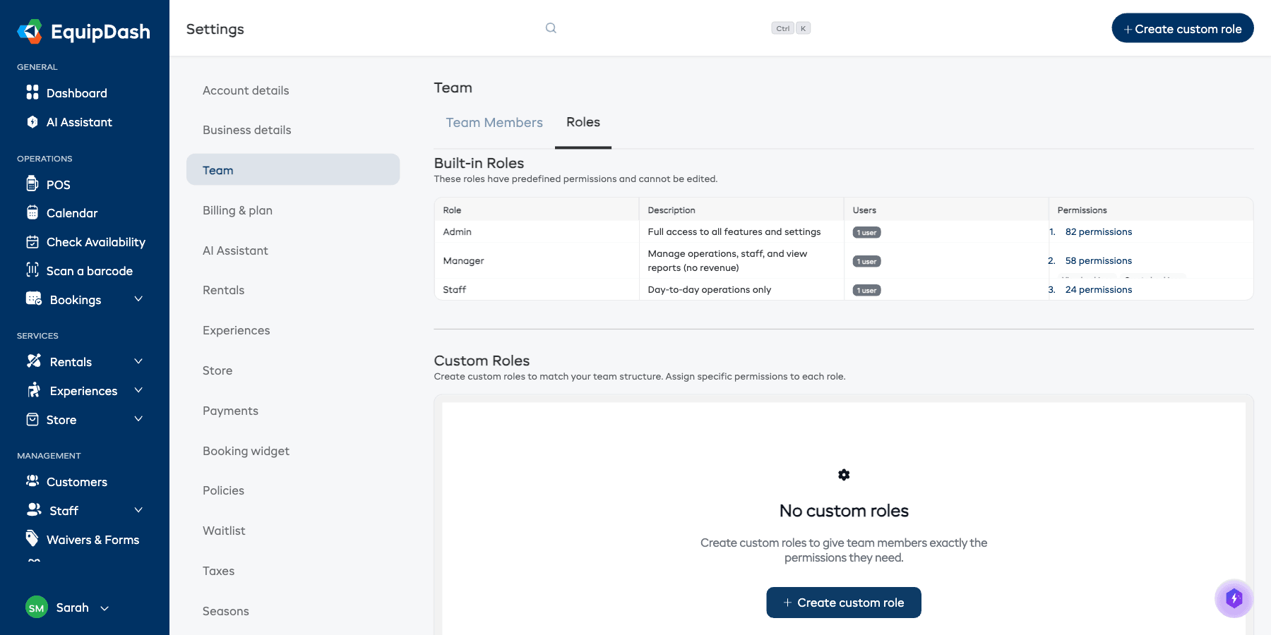 The Team Roles page showing built-in roles (Admin, Manager, Staff) with their descriptions, user counts, and permission counts, plus a Custom Roles section below