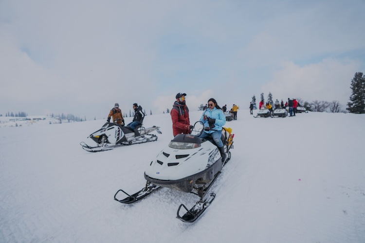 Snowmobile riders on the snow