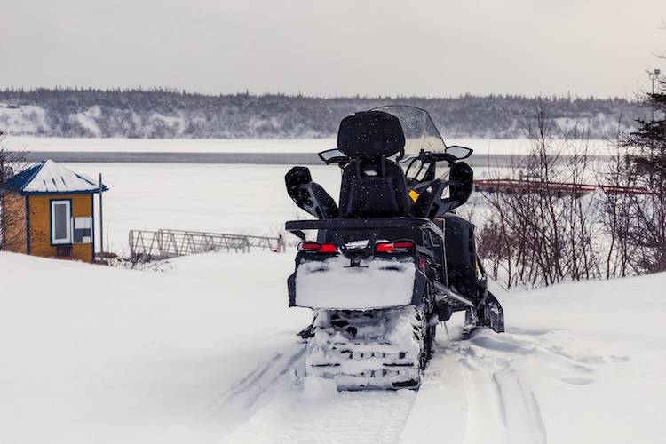 Snowmobile staging area in winter — weather reschedules