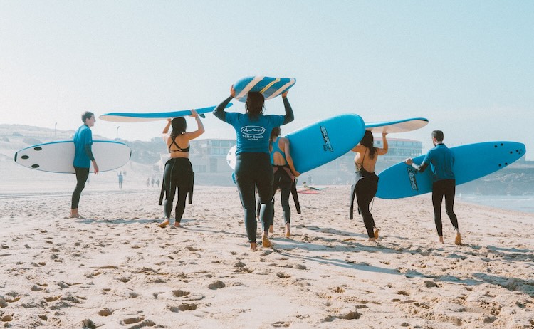 Surf lesson check-in and board assignment on the beach