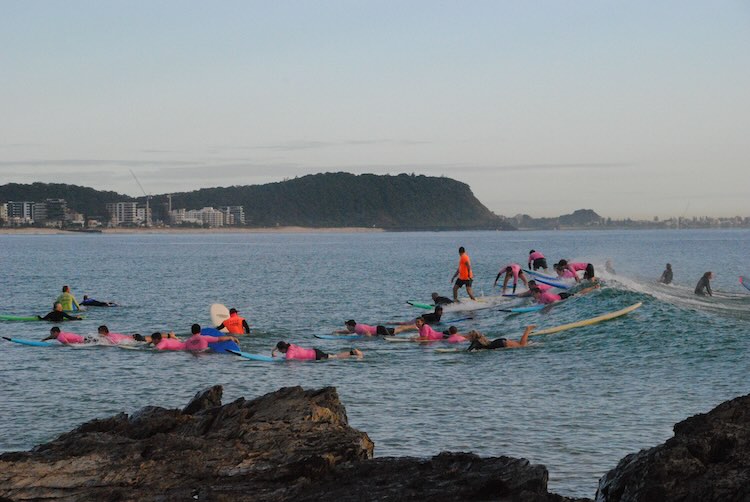 Surfboards on the beach — tide-aware lesson scheduling