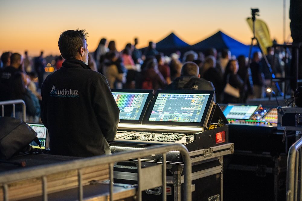 AV crew loading speakers and flight cases into a van for an event