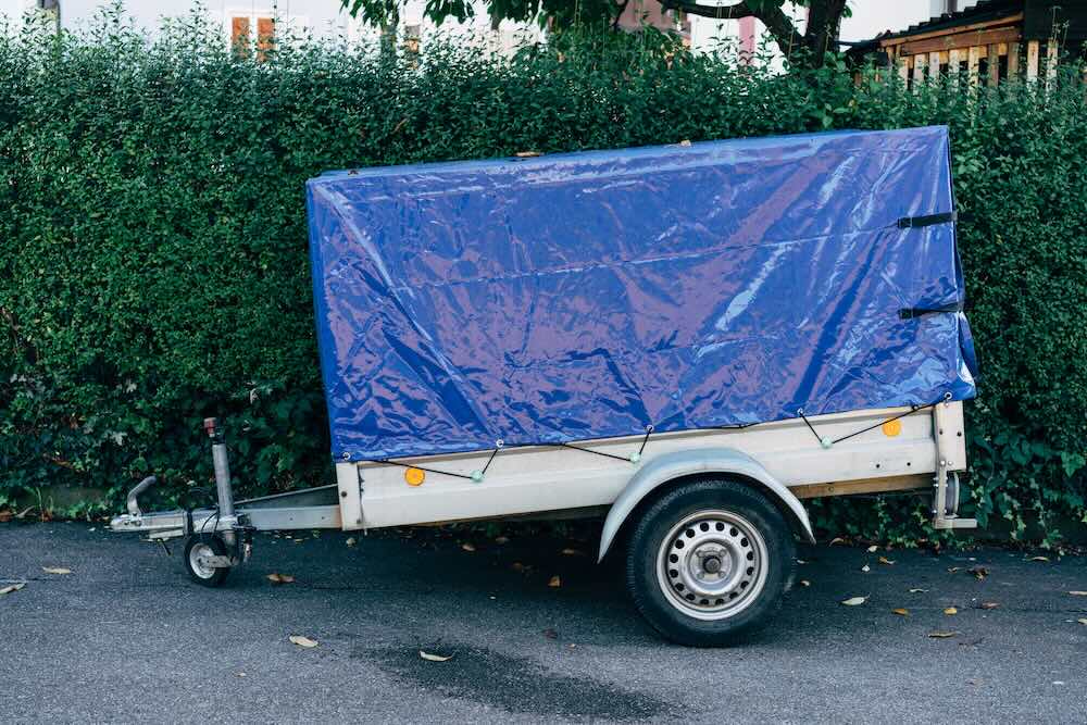 Trailer being hitched to a vehicle in a rental yard